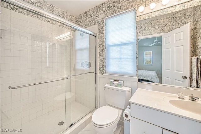 bathroom with vanity, toilet, and a shower with shower door