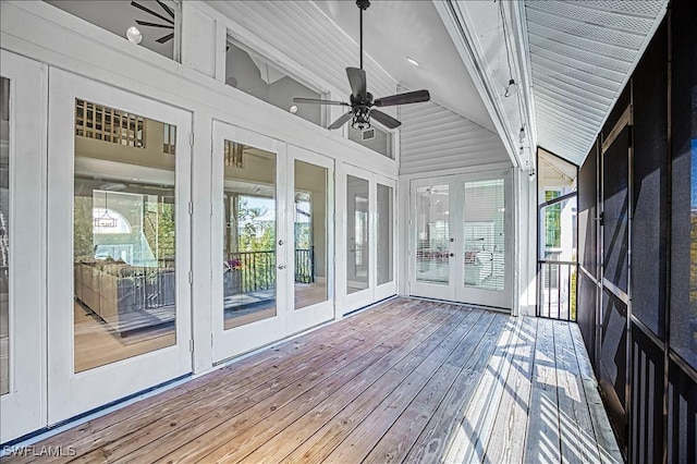 unfurnished sunroom with ceiling fan and lofted ceiling with beams