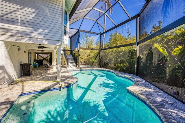 view of pool with a patio, a lanai, and ceiling fan