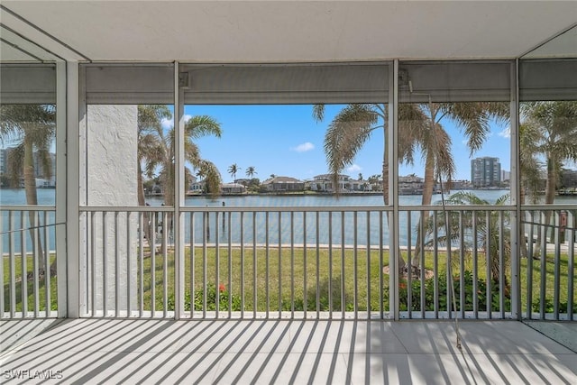 unfurnished sunroom with a water view