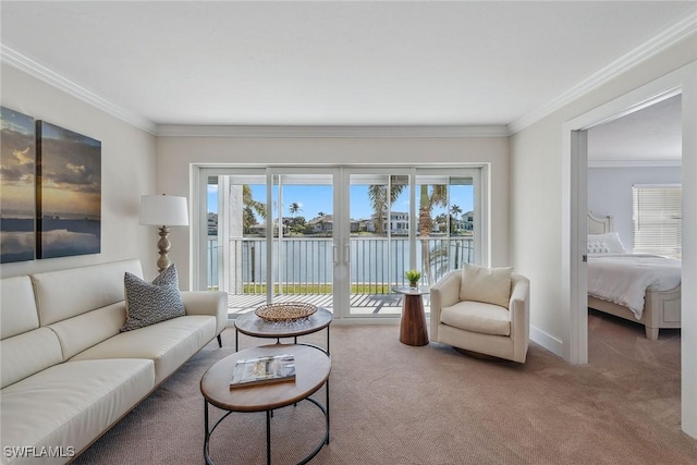 carpeted living room with a water view, ornamental molding, and a wealth of natural light