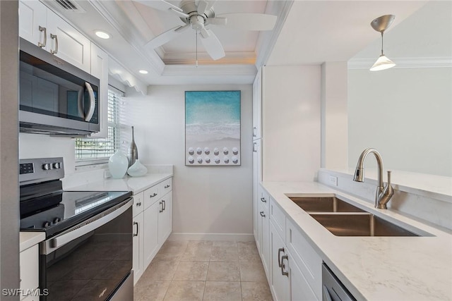 kitchen with sink, crown molding, appliances with stainless steel finishes, white cabinetry, and hanging light fixtures