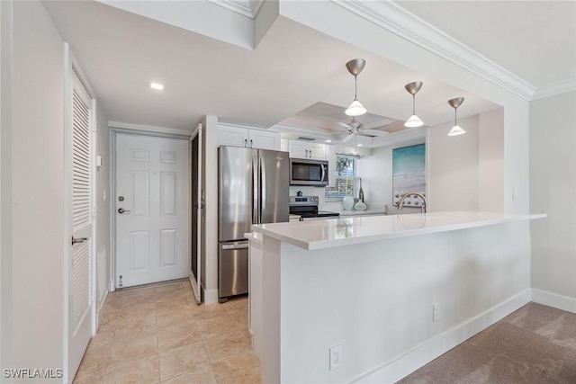 kitchen with appliances with stainless steel finishes, pendant lighting, white cabinetry, ornamental molding, and kitchen peninsula