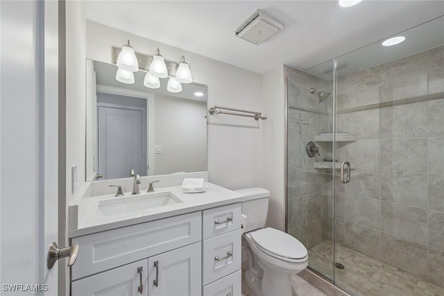 bathroom with vanity, toilet, and an enclosed shower