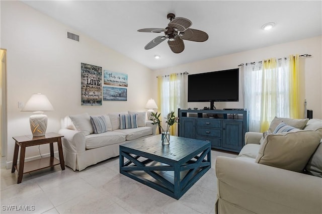 tiled living room with ceiling fan and vaulted ceiling