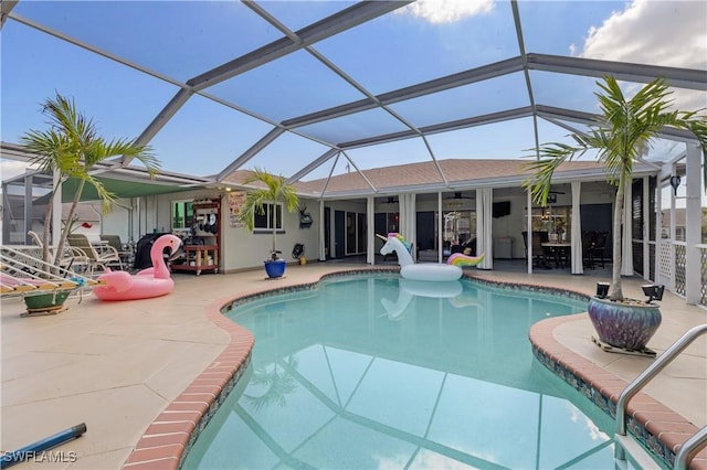 view of swimming pool featuring a patio area and glass enclosure