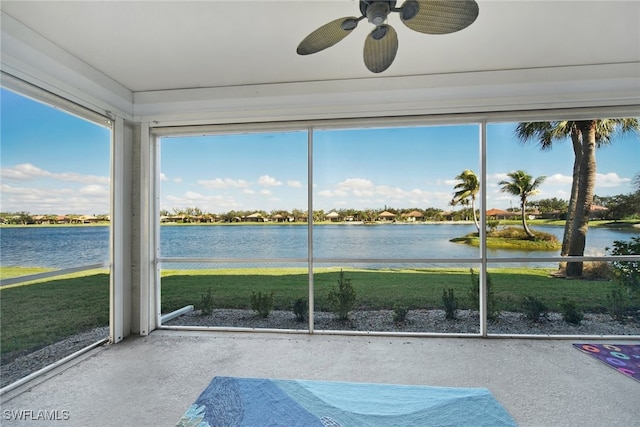unfurnished sunroom featuring concrete flooring and a water view