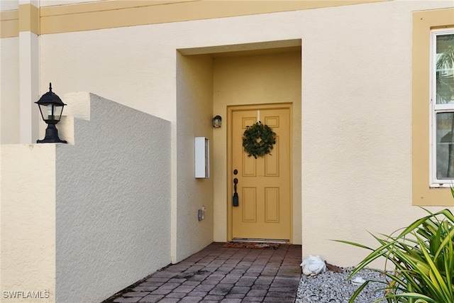 property entrance featuring stucco siding