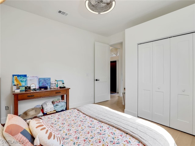 8850 Springwood Ct, Bonita Springs, FL 34135 - bedroom with light wood-type flooring, baseboards, a closet, and visible vents
