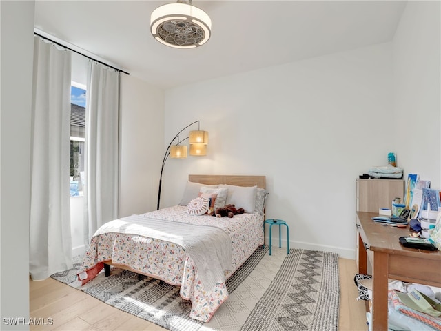 8850 Springwood Ct, Bonita Springs, FL 34135 - bedroom featuring baseboards and wood finished floors
