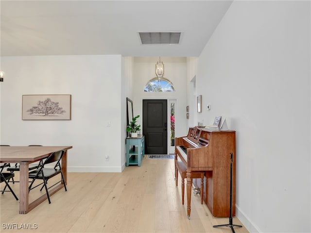 8850 Springwood Ct, Bonita Springs, FL 34135 - entryway with baseboards, visible vents, a notable chandelier, and light wood-type flooring