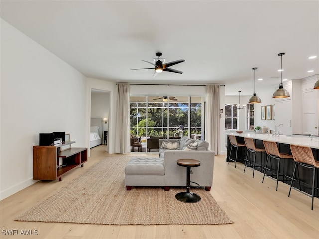 8850 Springwood Ct, Bonita Springs, FL 34135 - living room featuring a sunroom, recessed lighting, baseboards, light wood finished floors, and a ceiling fan