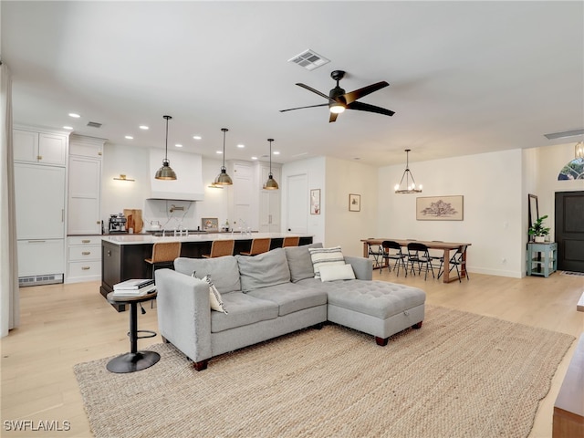 8850 Springwood Ct, Bonita Springs, FL 34135 - living room featuring light wood-style flooring, recessed lighting, a baseboard heating unit, and visible vents