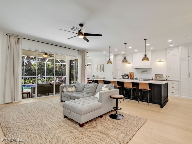 8850 Springwood Ct, Bonita Springs, FL 34135 - living area with a sunroom, recessed lighting, visible vents, light wood-style flooring, and ceiling fan