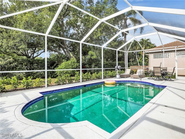 8850 Springwood Ct, Bonita Springs, FL 34135 - pool with glass enclosure and a patio area