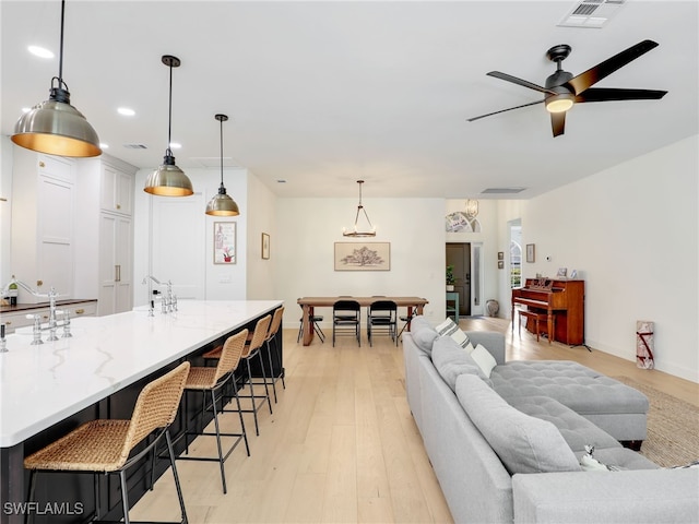 8850 Springwood Ct, Bonita Springs, FL 34135 - living room featuring a ceiling fan, baseboards, light wood-style floors, and visible vents