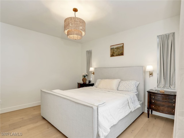 8850 Springwood Ct, Bonita Springs, FL 34135 - bedroom with baseboards and light wood-type flooring