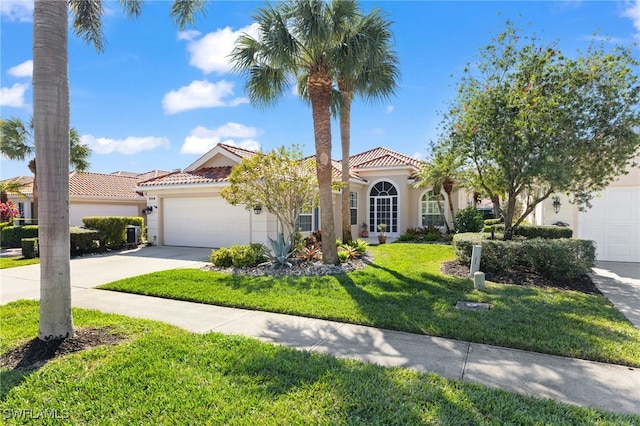 mediterranean / spanish-style home featuring a garage and a front lawn