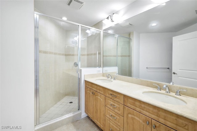 bathroom with vanity and a shower with door