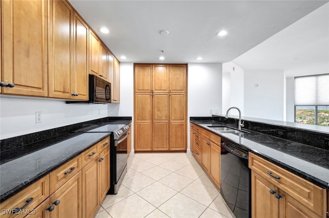 kitchen featuring dark stone countertops, recessed lighting, light tile patterned flooring, black appliances, and a sink