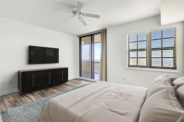 bedroom with ceiling fan, floor to ceiling windows, access to exterior, and dark hardwood / wood-style flooring