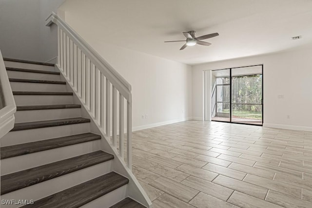 stairway with ceiling fan