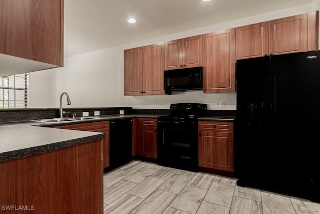 kitchen featuring sink, black appliances, and kitchen peninsula