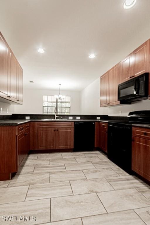 kitchen featuring pendant lighting, sink, and black appliances