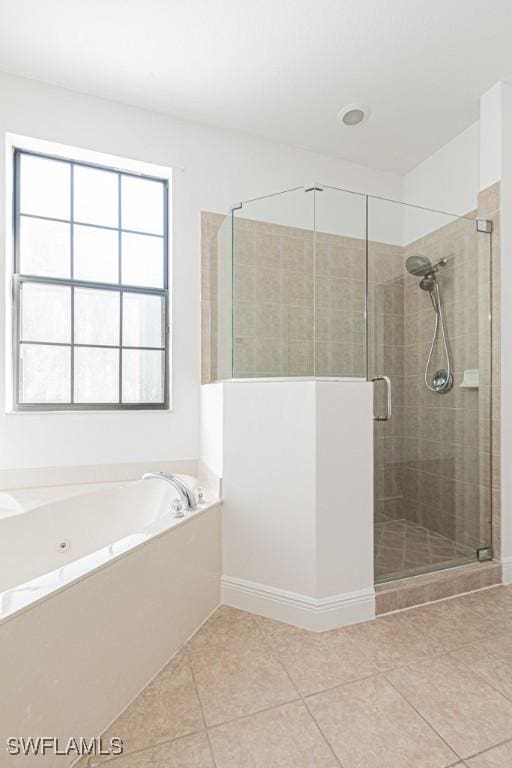 bathroom with independent shower and bath and tile patterned floors