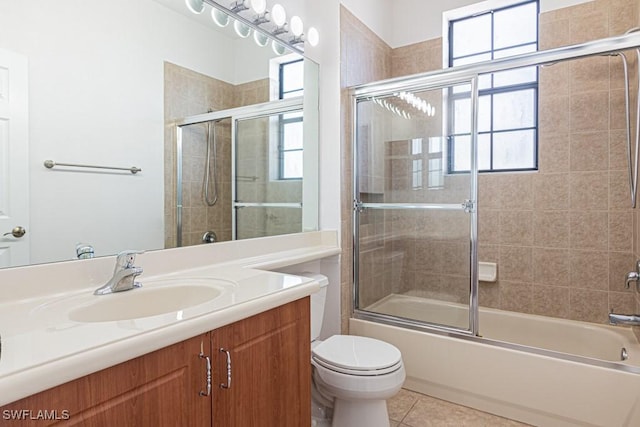 full bathroom with vanity, tile patterned floors, shower / bath combination with glass door, and toilet