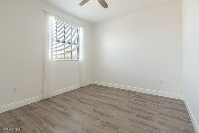 spare room featuring hardwood / wood-style floors and ceiling fan