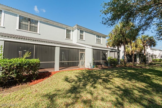 back of house featuring a yard