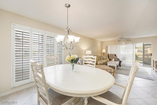 dining room featuring light tile patterned flooring and ceiling fan with notable chandelier