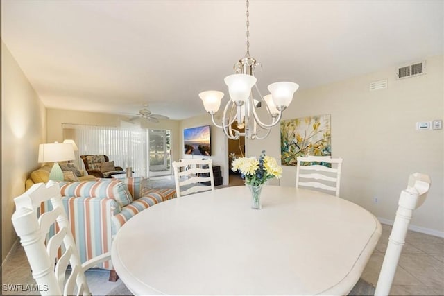 dining area featuring light tile patterned floors, baseboards, visible vents, and ceiling fan with notable chandelier