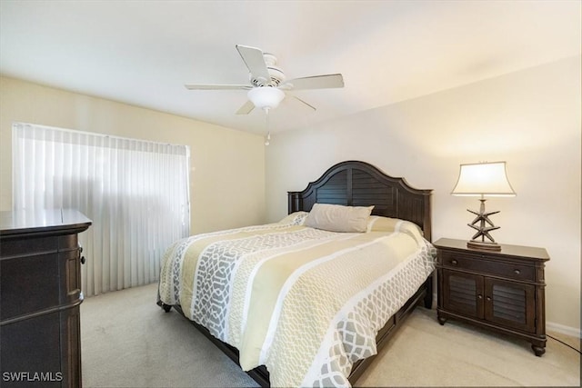 bedroom with ceiling fan and light colored carpet