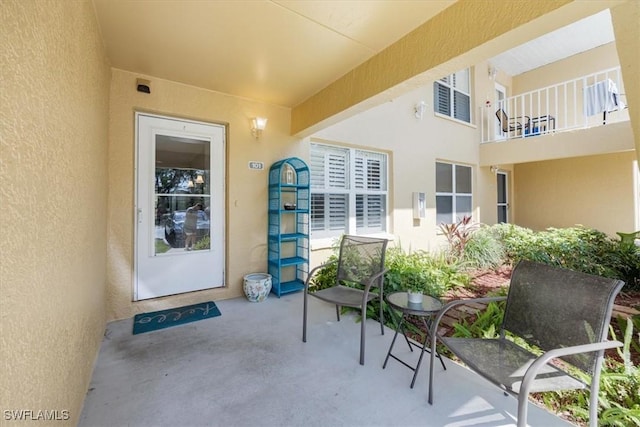 property entrance featuring a patio area and stucco siding