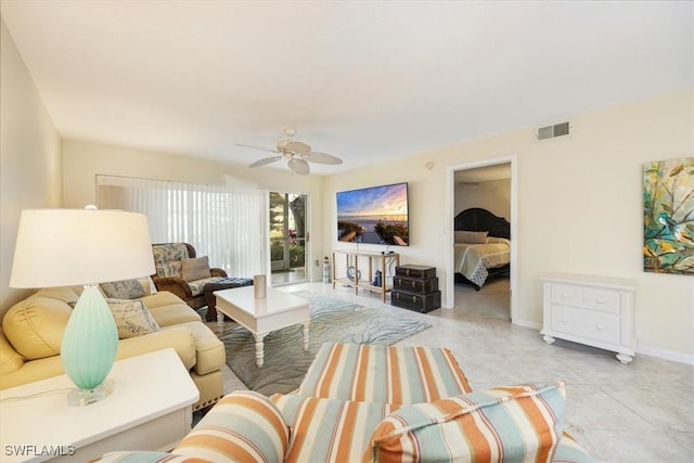 living room featuring a ceiling fan, visible vents, baseboards, and light tile patterned flooring