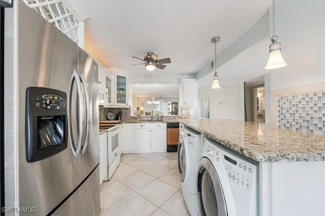 kitchen with pendant lighting, stainless steel appliances, tasteful backsplash, glass insert cabinets, and white cabinetry