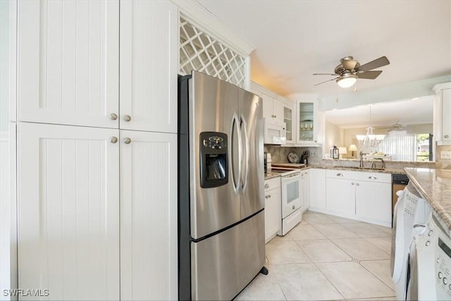 kitchen featuring light stone counters, glass insert cabinets, white cabinets, a sink, and white appliances