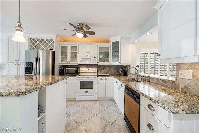 kitchen with white appliances, glass insert cabinets, decorative light fixtures, white cabinetry, and a sink