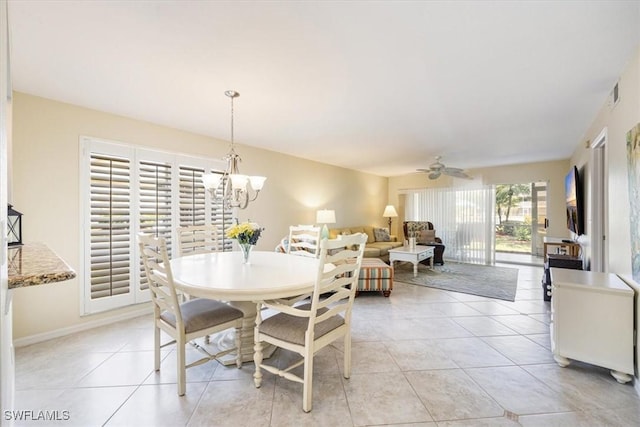 dining area featuring light tile patterned floors, ceiling fan with notable chandelier, visible vents, and baseboards