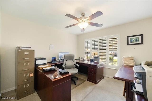 office with a ceiling fan, light colored carpet, and baseboards