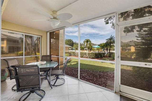 sunroom featuring a ceiling fan