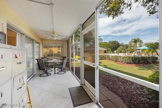 sunroom featuring ceiling fan