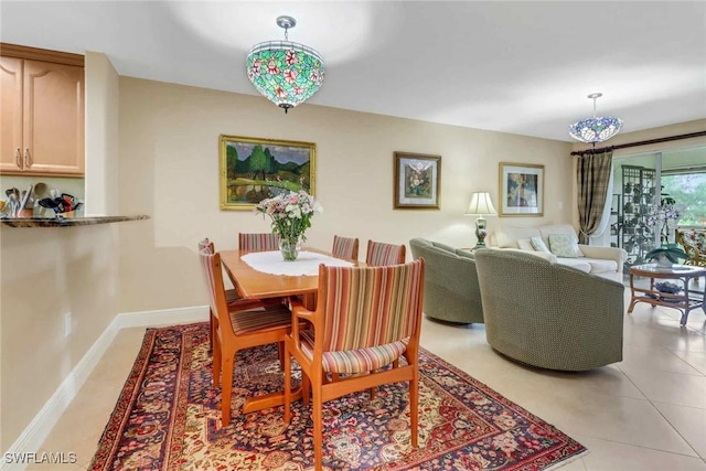 dining room with light tile patterned flooring and baseboards