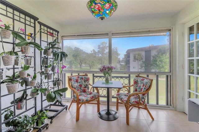 5595 Rattlesnake Hammock Rd Unit C-19, Naples, FL 34113 - sunroom featuring tile patterned flooring
