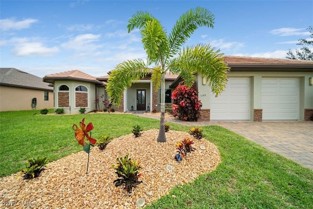 view of front facade with a garage and a front yard