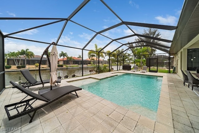 view of pool with a water view, a patio, and glass enclosure