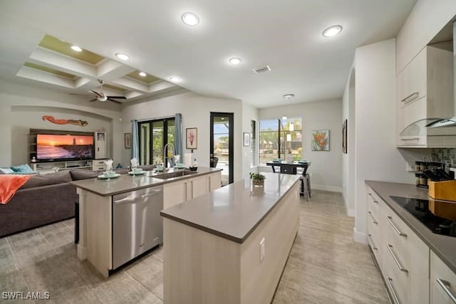 kitchen with sink, black electric stovetop, white cabinets, a center island with sink, and stainless steel dishwasher