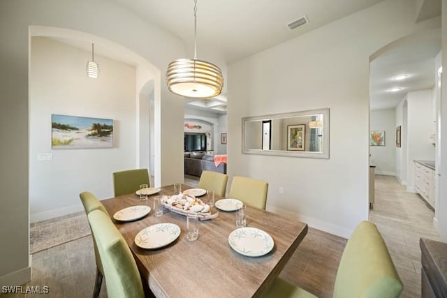 dining space with light hardwood / wood-style flooring